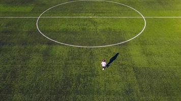 a little teenage girl is running fast on the football field of the stadium striving for victory photo