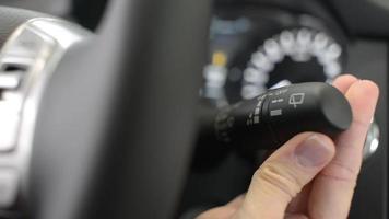 Close-up of a female hand pushing the Lever of Windshield Washers video