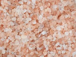 Himalayan salt pink crystals as a background. Texture made of pink rocky salt.