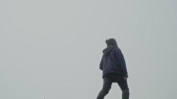 A hiker photographer taking pictures of morning landscape in winter mountains video