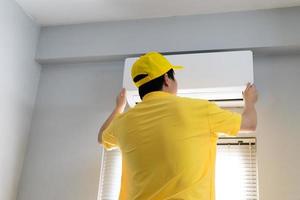 Repairmen are periodically repairing and cleaning the air conditioner photo