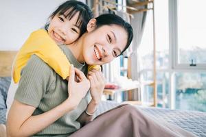 Asian mother and daughter at home together photo