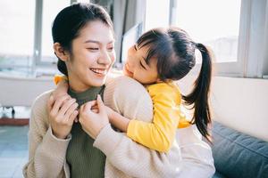 Asian mother and daughter at home together photo