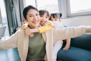 Portrait of Asian mother and daughters at home photo