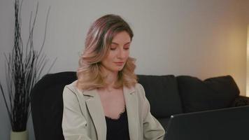 Portrait of pretty business woman in gray suit working video