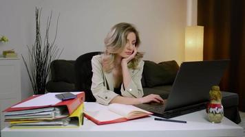 Business woman falling asleep at desk, sitting at table with laptop. video