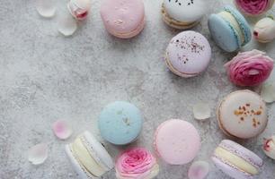Beautiful colorful tasty macaroons on a concrete background photo