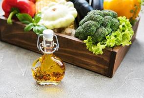 different raw vegetables and olive oil photo