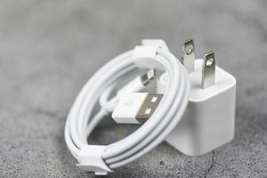 Electrical adapter smartphone usb port charger wire on gray background - Mobile Phone Charger Adapter photo