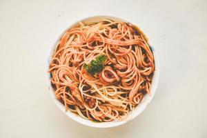 Spaghetti italian pasta served on bowl plate with parsley italian food and menu concept - spaghetti bolognese top view , with grunge noise photo