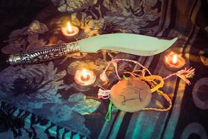 Astrology Occult Magic illustration and candlelight burning candle on the darkness background Magic Spiritual Horoscopes and Palm reading fortune teller concept - knife vampire