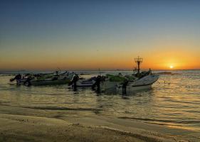 barcos de pescadores al atardecer foto