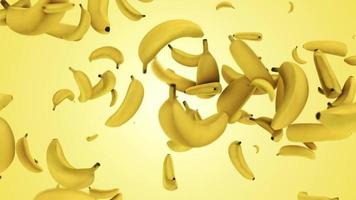 Plátanos maduros brillantes frescos cayendo sobre un hermoso fondo amarillo video