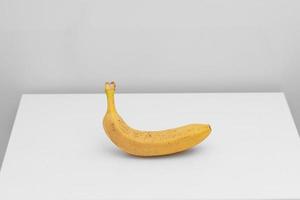 Single yellow ripe banana isolated on white background. Fiber fruits photo