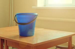 blue bucket on the table by the window