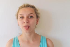 girl with blond hair plays facial expressions, builds faces photo