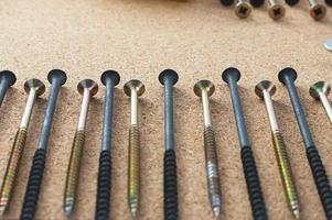 Repair. Self-tapping screws on the desktop. The concept of a repair shop. photo