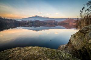 Tranquil lake scenery view at sunset photo