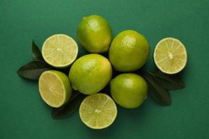 Ripe lime on green background, top view photo