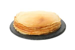 Tray with thin pancakes isolated on white background photo