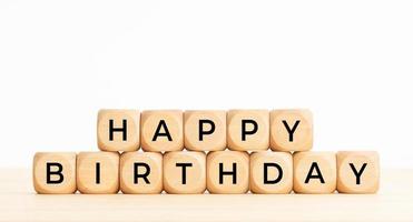 Happy Birthday phrase in wooden blocks on table. Copy space photo
