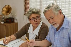 Senior couple having financial problems need discussing financial plans whit financial advisor. photo