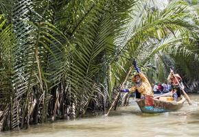 MEKONG DELTA, VIETNAM, 2017 - Unidentified people in the boat at Mekong Delta in Vietnam. Boats are the main means of transportation in Mekong Delta.