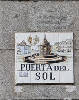MADRID, SPAIN, 2016 - Closeup of the street sign. Street signs in Madrid are hand-painted ceramic tiles typically composed within 9 or 12 tiles. They depict the name of the alley or street. photo
