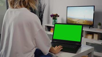 Woman Using Laptop Green Screen after work in the evening home. video