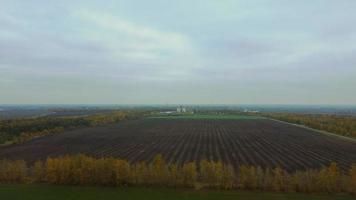aerial survey of an agricultural field after harvesting , drone flight at a height above the arable land.