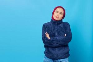 Portrait of sad young Asian woman crossed arms while looking up to empty space photo