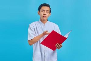 Portrait of a male nurse holding a folder with a surprised face over a blue background photo