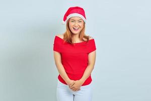 Portrait of young Asian woman wearing christmas dress standing and showing cheerful expression. christmas concept photo