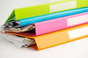 File Folder Binder stack of multi color on table in business office. photo