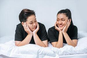 Two beloved young women slept in bed together. photo