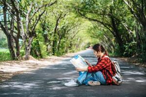 Sitting and watching the map on the road. photo