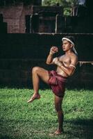 A boxer tied a rope in his hand and performed a fight, The martial arts of Muay Thai. photo