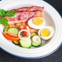 English breakfast bacon, egg, tomato, cucumber, toast bread photo
