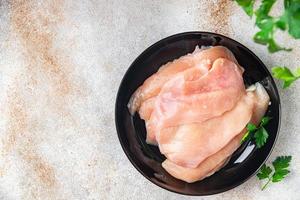 raw chicken breast slices poultry meat keto or paleo diet photo