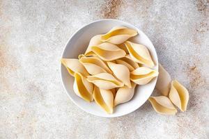 conchiglie pasta raw big shell durum wheat semola flour photo