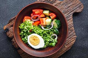 vegetables salad boiled egg cucumber, tomato, onion, lettuce healthy keto or paleo diet photo