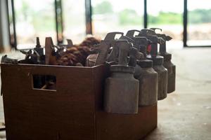 Closeup group of color sprayers hanging on the edge of wooden wagon standby for using. photo