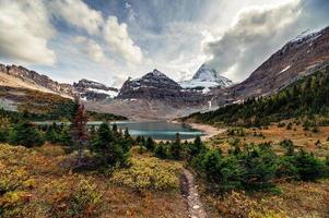 Mount Assiniboine with autumn forest at Lake Magog on provincial park
