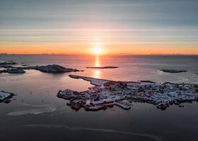 Above of sunrise over Reine village on coastline in winter at Lofoten islands photo