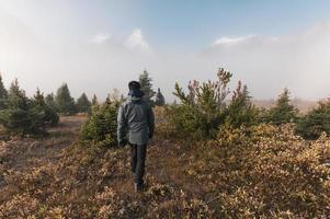 Man traveler walking on field with foggy in rocky mountains at Assiniboine provincial park photo