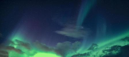 Aurora Borealis or Northern Lights with starry glowing in the night sky photo