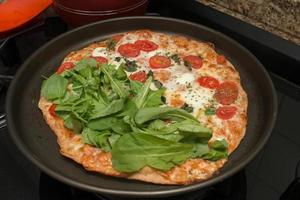 Delicious Homemade Pizza Margherita Ready to be Sliced and eaten photo