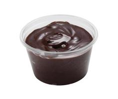 Chocolate cream in plastic cup on white background photo