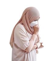 Muslim woman wearing a surgical mask feeling sick on white background photo