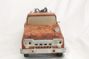 Early 1960s Vintage Red Number 5 Fire truck that has rusted out and seen better days photo